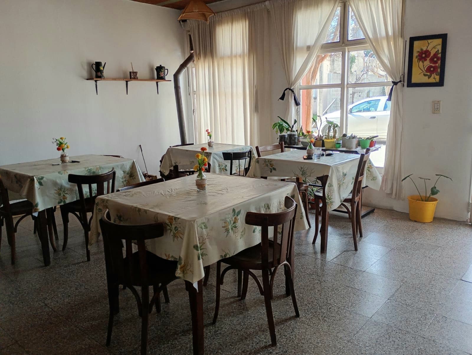 Desayunador con mesas vestidas junto al ventanal